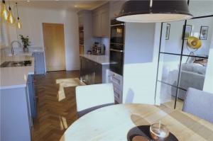 Doors from the Oxford collection in grey and copper handles with Silestone Lagoon worktops and appliances by Neff
