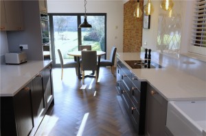 Shaker style kitchen in two tones of grey with quartz worktops including cutting a section of wall out to install a critical style glass panel and new amtico flooring throughout all the ground floor