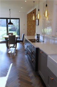 Shaker style kitchen in two tones of grey with quartz worktops including cutting a section of wall out to install a critical style glass panel and new amtico flooring throughout all the ground floor