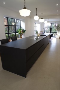 Matte Black kitchen with Dekton Domoos worktop / Calcutta gold quartz tabletop and Bora Basic glass ceramic induction cooktop and appliances by Siemens