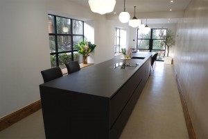 Matte Black kitchen with Dekton Domoos worktop / Calcutta gold quartz tabletop and Bora Basic glass ceramic induction cooktop and appliances by Siemens