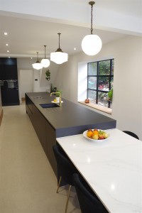 Matte Black kitchen with Dekton Domoos worktop / Calcutta gold quartz tabletop and Bora Basic glass ceramic induction cooktop and appliances by Siemens