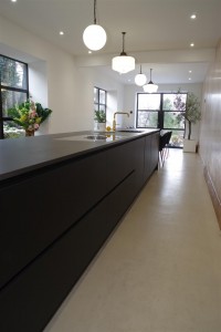 Matte Black kitchen with Dekton Domoos worktop / Calcutta gold quartz tabletop and Bora Basic glass ceramic induction cooktop and appliances by Siemens
