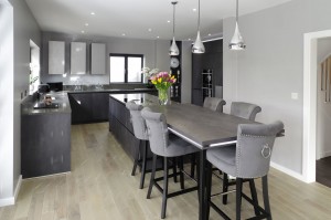 large open plan grey kitchen with island and connected breakfast bar