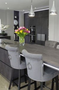 large open plan grey kitchen with island and connected breakfast bar