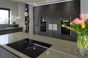 BORA Pure Induction cooktop on kitchen Island / Neff Slide & Hide single ovens, steam oven and microwave either side of secret utility room door